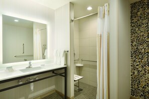 A bathroom with a mirror, sink, and shower area. - Hilton Garden Inn Pittsburgh Airport South-Robinson Mall (Pittsburgh)