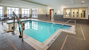 An indoor swimming pool with clear water, a shallow water area, and a lifeguard chair. - Hilton Garden Inn Pittsburgh Airport South-Robinson Mall (Pittsburgh)