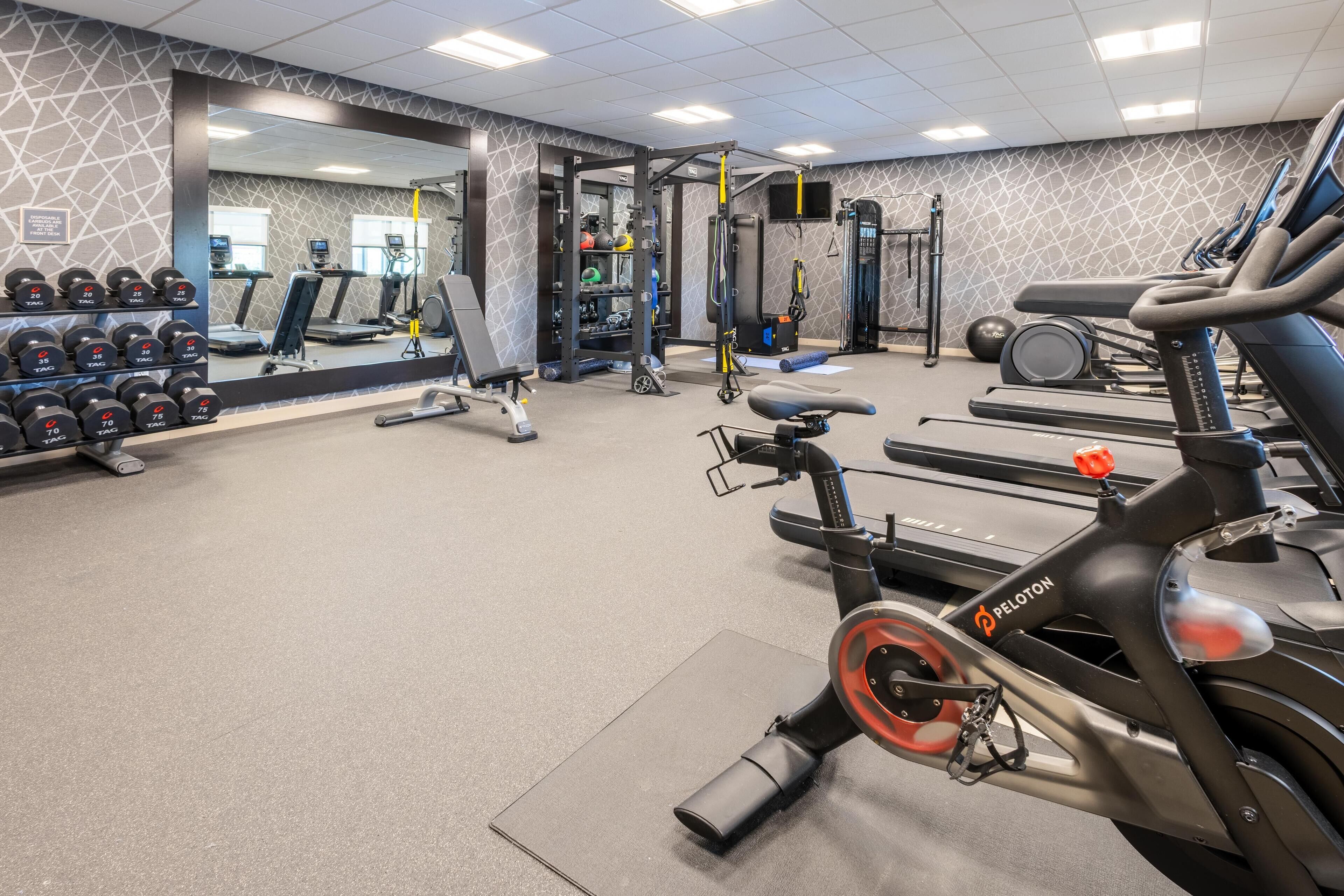 A gym with treadmills, stationary bikes, and weight machines.