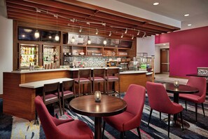 A bar area with a wooden ceiling, bar stools, and a counter with a menu. - Residence Inn Orlando Lake Nona (Orlando)