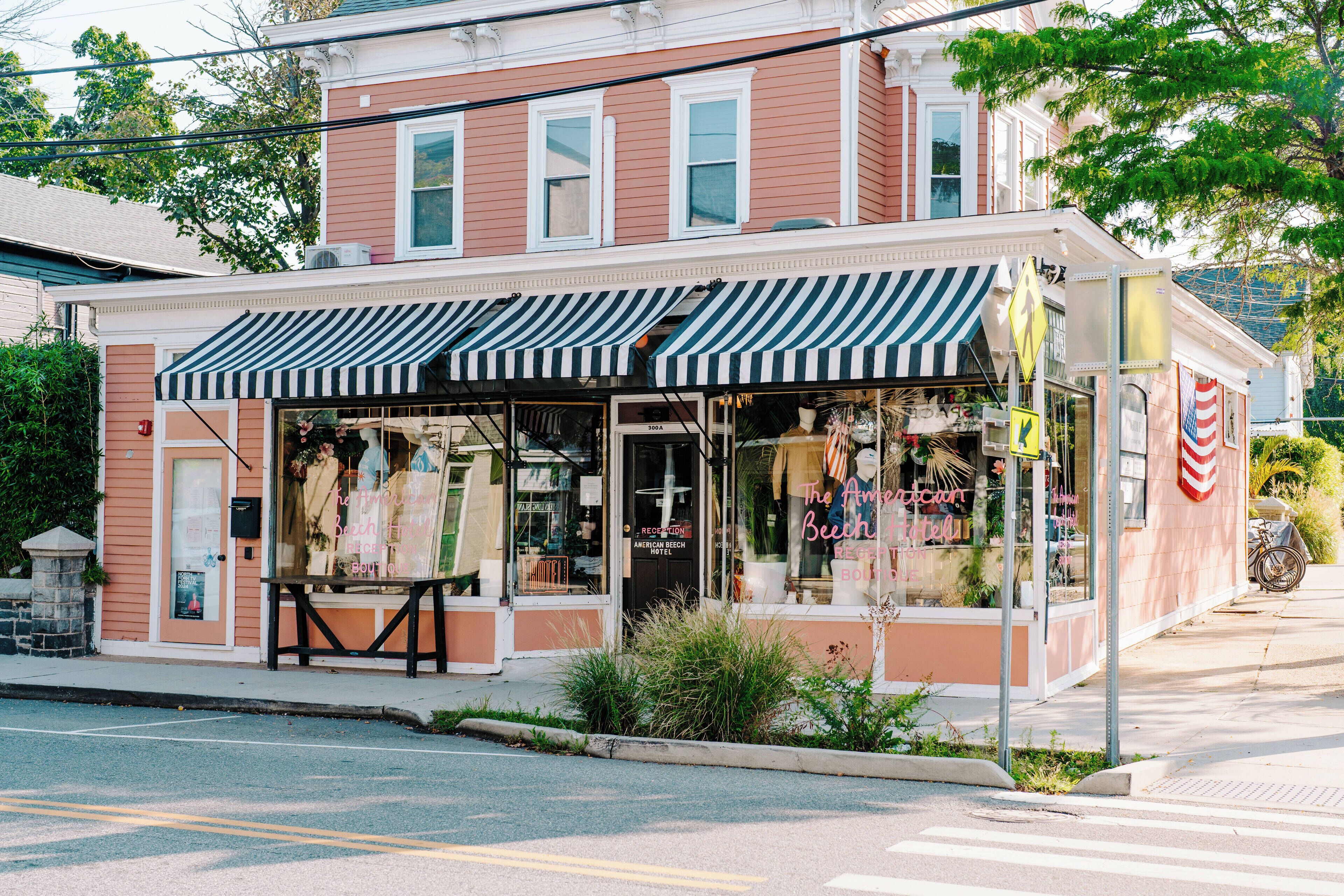 A two-story building with a storefront featuring a striped awning.