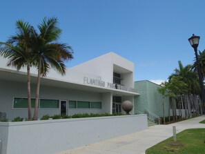 A modern building with a sign reading "FLAMINGO PAX TENNIS CENTER". - SoBe Apartments (Miami Beach)