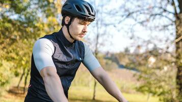 A person riding a mountain bike in a natural setting with trees and grass.