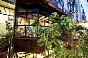A hotel with a modern design, featuring a balcony with wooden railings and potted plants. - CHAOS BOUTIQUE HOTEL (Kuala Lumpur)