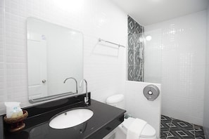 A modern bathroom with a black sink, white toilet, and a mirror. - Gusto House (Chiang Mai)
