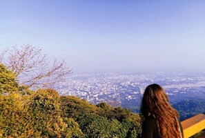 A person overlooking a cityscape from a high vantage point. - Gusto House (Chiang Mai)