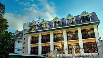 Stunning residential building with a symmetrical facade, featuring balconies and ornate railings.