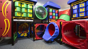 Children can play safely on the carpeted play area featuring climbing tubes, a tunnel slide, and a climbing dome.