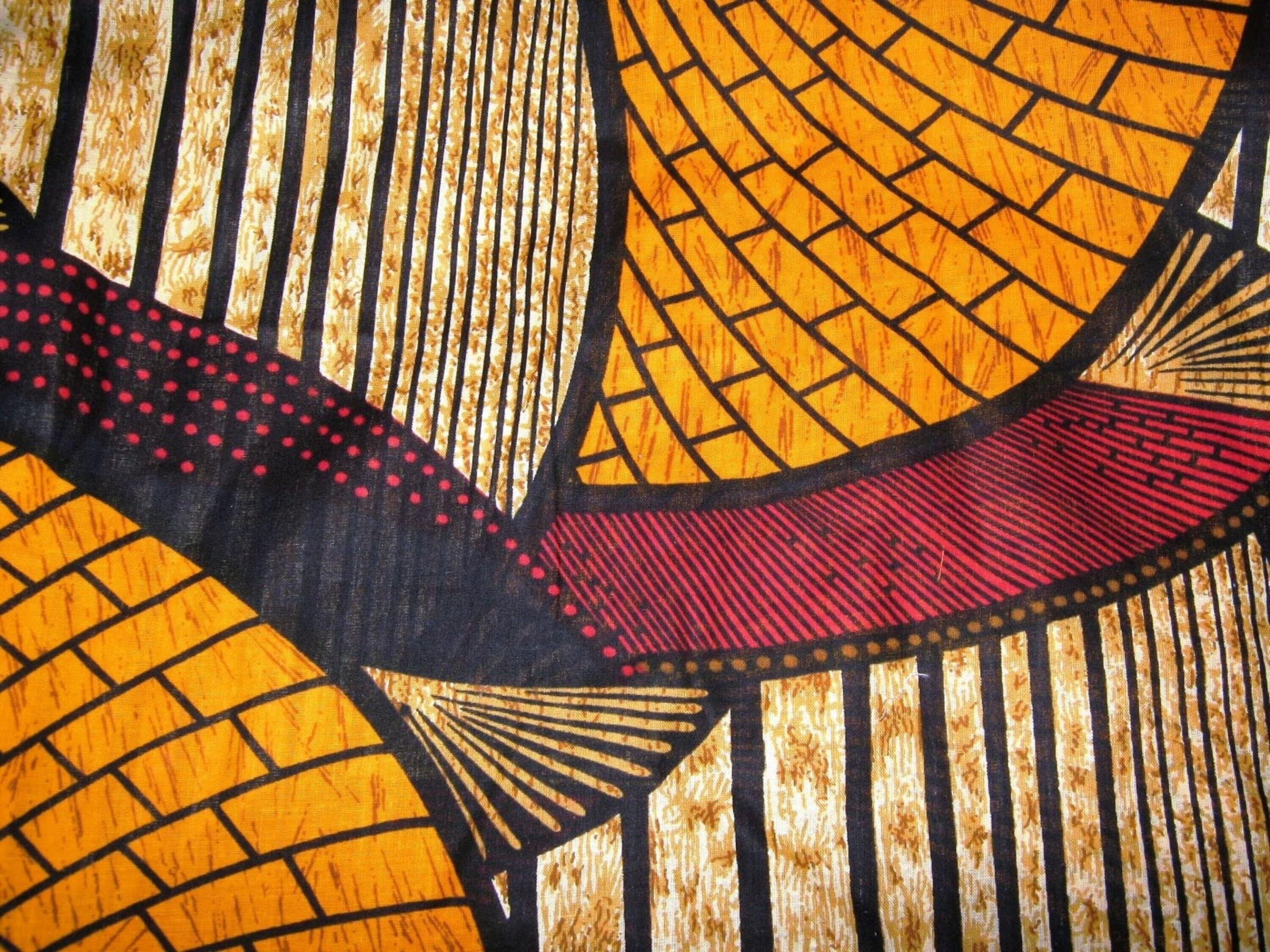A close-up of a patterned fabric with geometric shapes and lines.