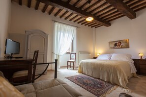 Triple Room | Minibar, in-room safe, desk, cots/infant beds