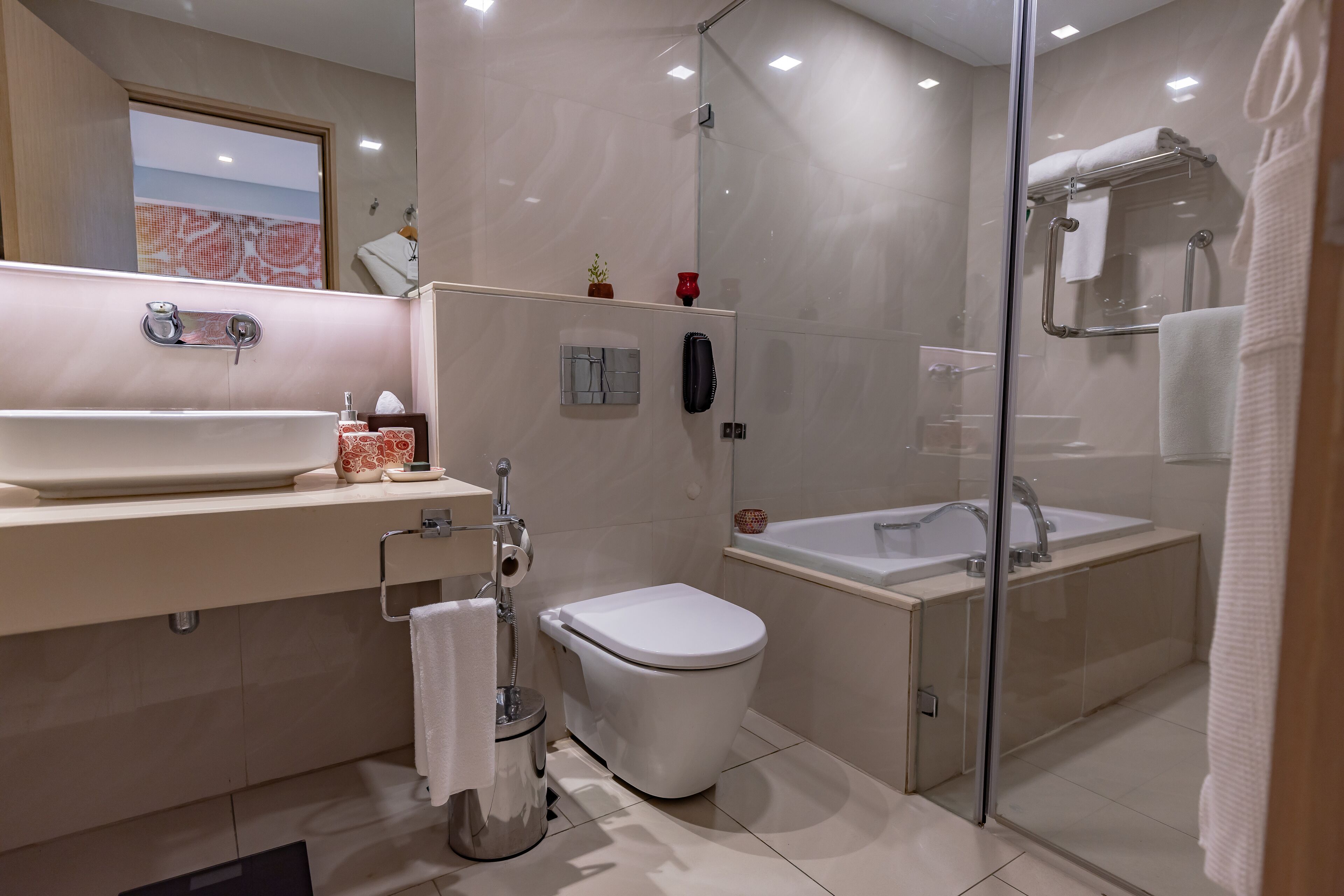 A modern bathroom with a large sink, toilet, and bathtub.