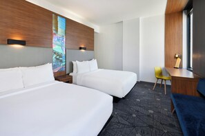 A hotel room with two beds, a desk, a chair, and a large window. - Aloft by Marriott Greenville Downtown (Greenville)