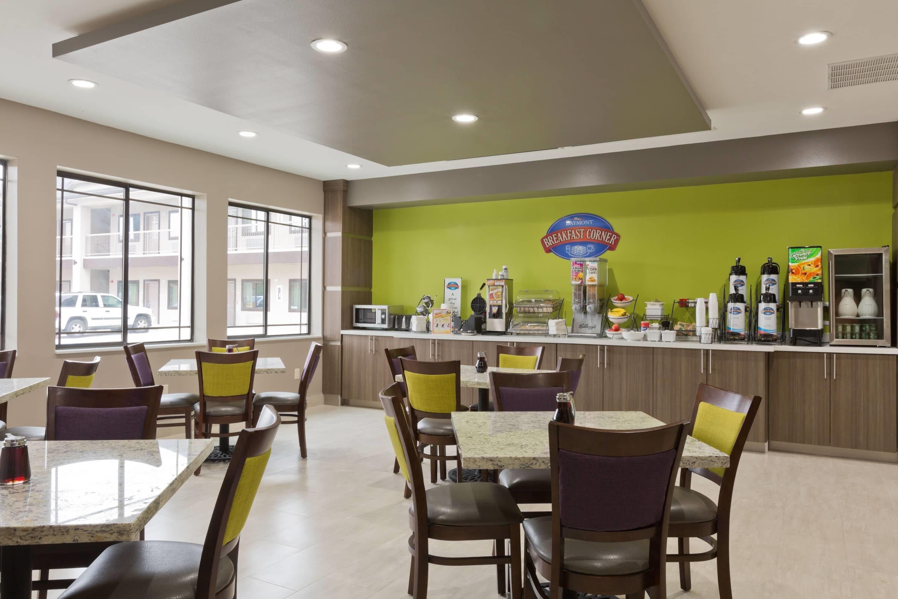 A breakfast counter with various food items and a sign that reads 'Breakfast Corner.'