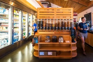A grocery store interior with refrigerated sections on the left and a variety of products on shelves.
