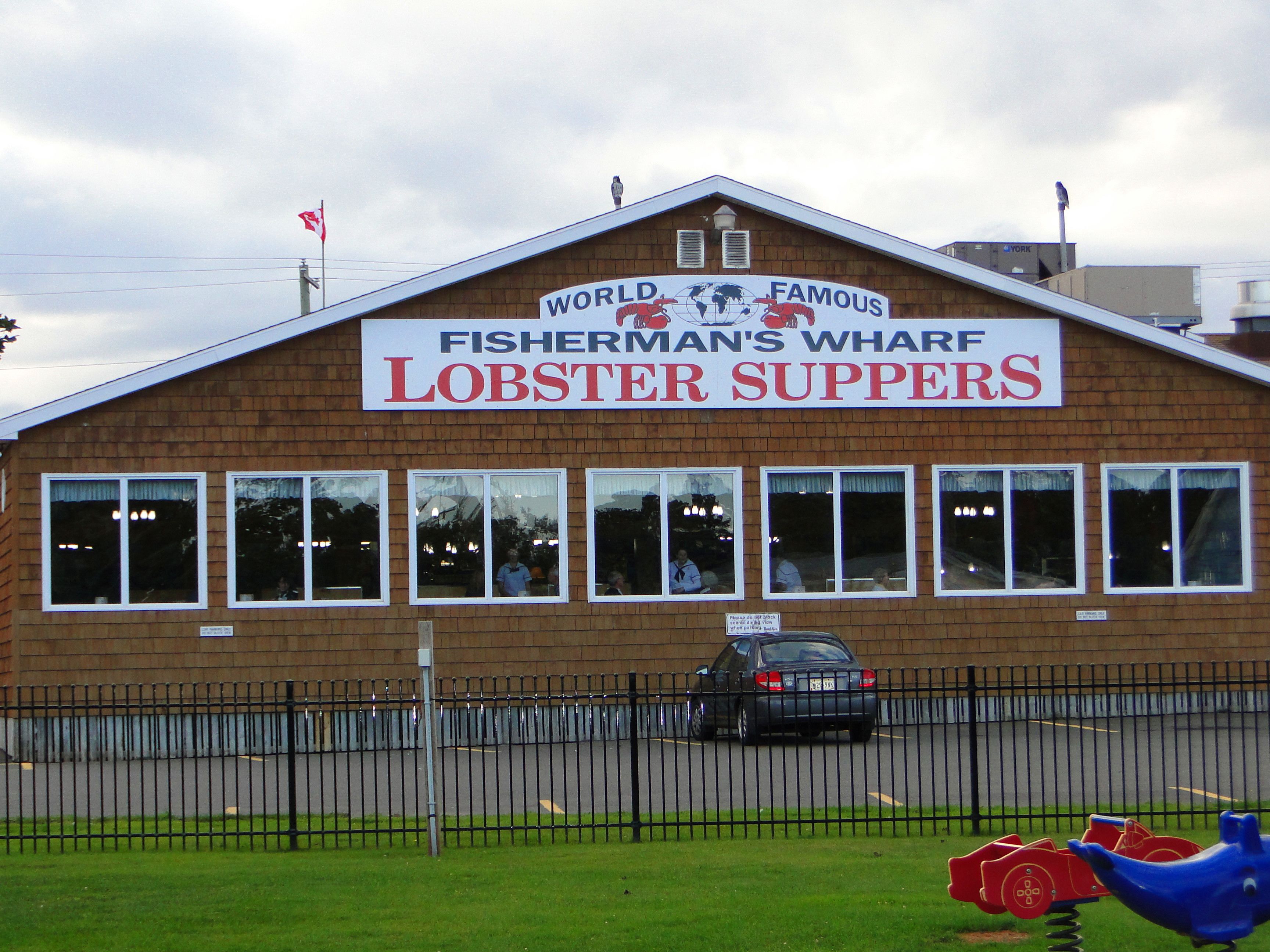 A brick building with a sign reading "Fisherman's Wharf Lobster Suppers".