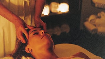 A person receiving a head massage.