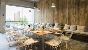 A conference room with a long table, chairs, and a sofa.