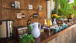 A wooden interior with a kitchen counter, various kitchen appliances, and decorative items.