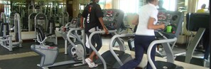 A gym with treadmills, weight machines, and a mirrored wall. - Boma Inn (Nairobi)