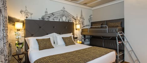 A bedroom with a large bed, a bunk bed, a nightstand with a lamp, and a wall mural.