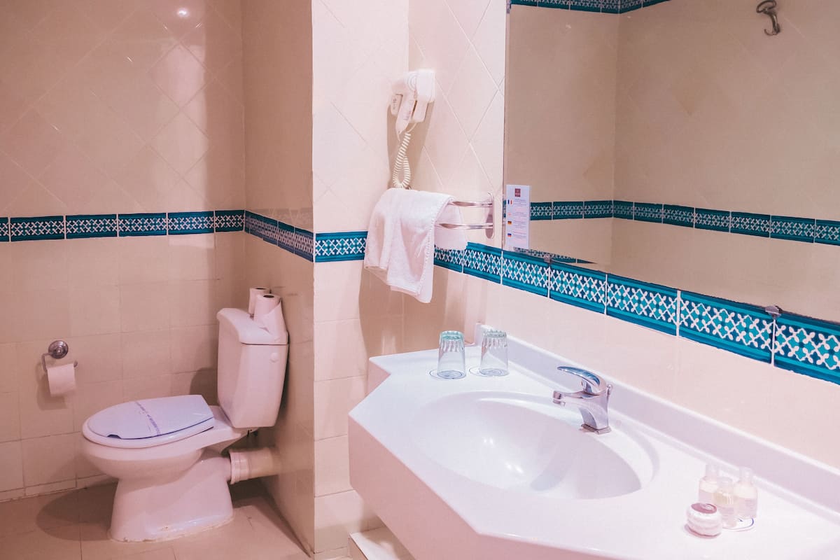 separate bathtub and shower, hair dryer, towels, soap