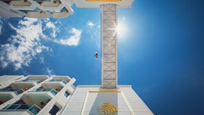 A modern hotel with a prominent tower and balconies. - Golden Orange Hotel (Konyaalti)