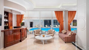 A spacious living area with a pool view, a bar, and a sofa. - Golden Orange Hotel (Konyaalti)