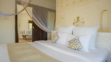 A bedroom with a bed, a canopy, and a decorative headboard.