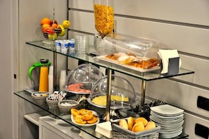 Una mesa de buffet con diversos alimentos y salsas.