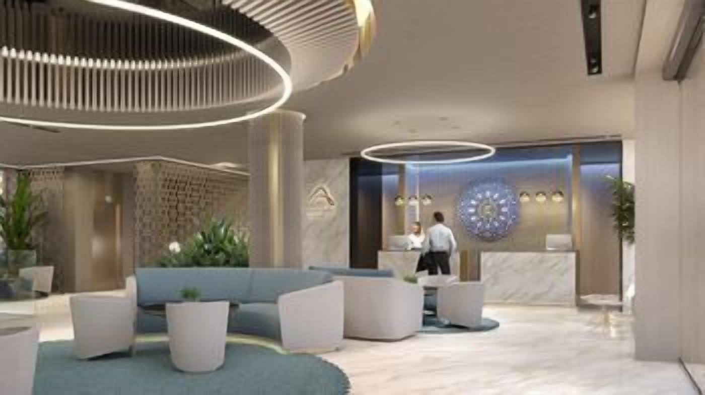A modern lobby with a reception desk, seating area, and decorative lighting.