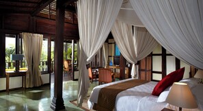 A room with a bed, a desk, and a chair. There are curtains and a window. - Mesastila Resort and Spa Magelang (Losari)