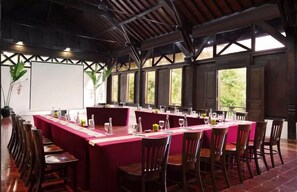 A conference room with a long table, chairs, and a whiteboard. - Mesastila Resort and Spa Magelang (Losari)