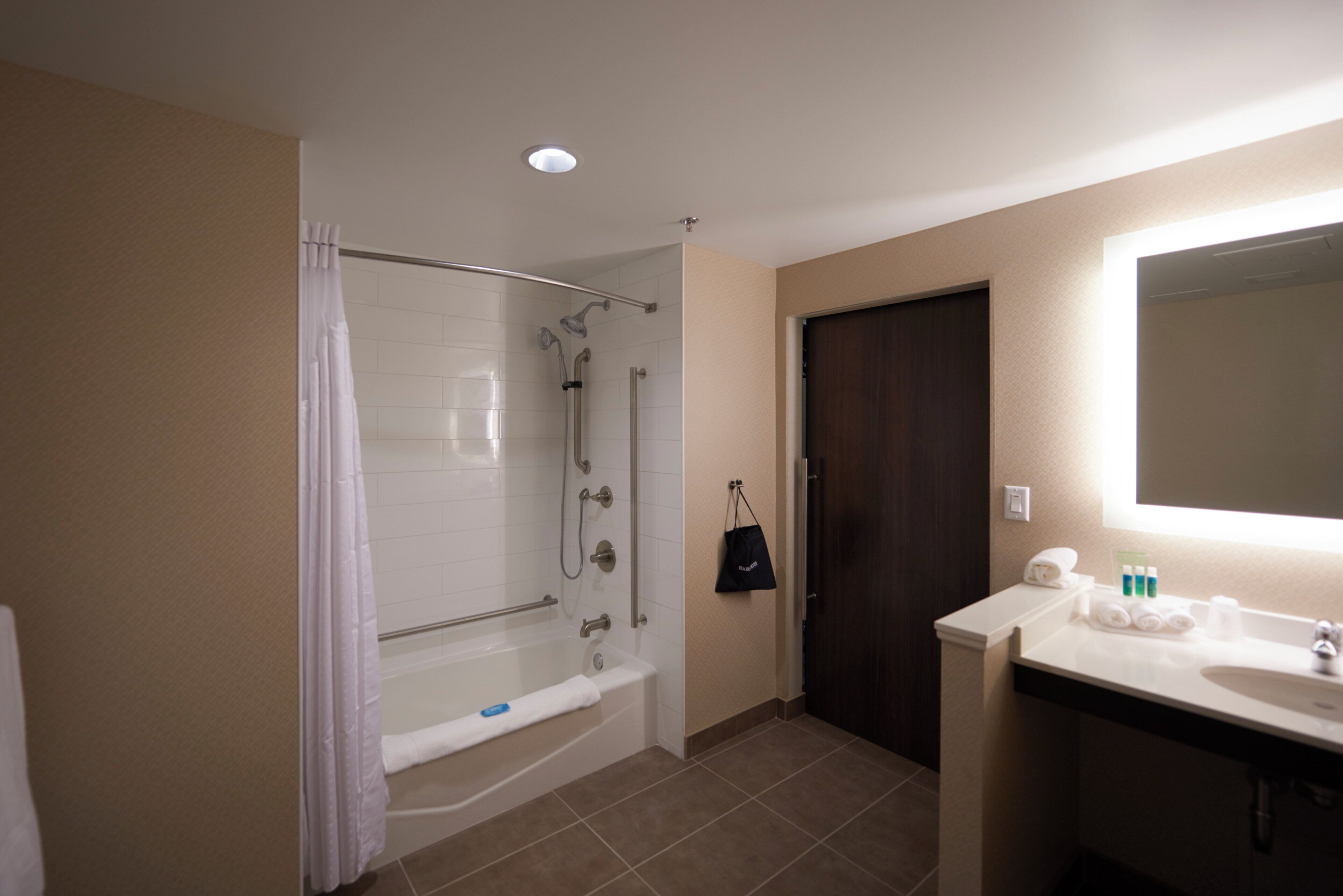 A bathroom with a bathtub, shower, and sink.