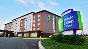 A Holiday Inn Express & Suites hotel with a modern facade, large windows, and a prominent signage. - Holiday Inn Express & Suites St John's Airport by IHG (St. John's)