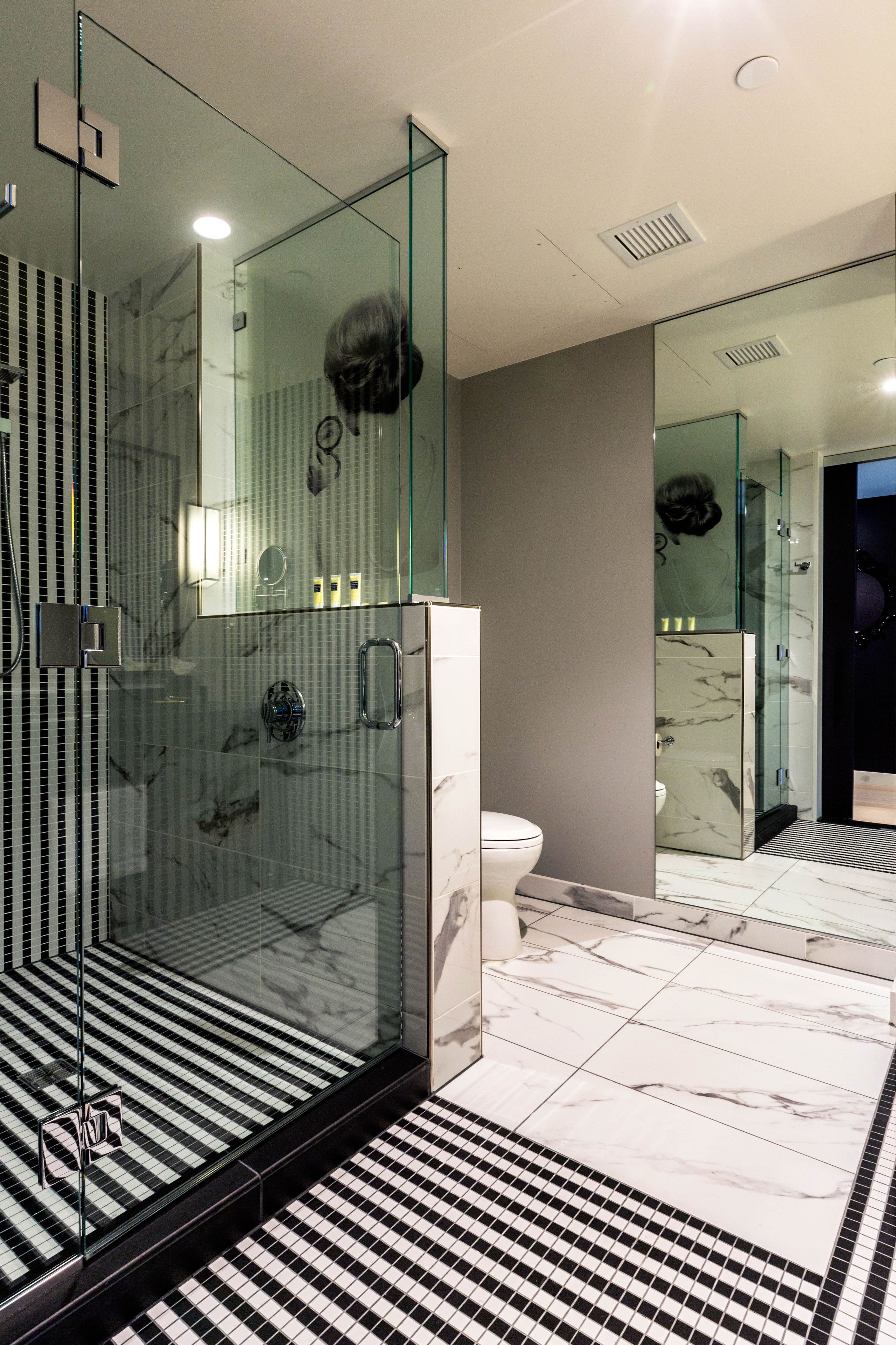 shower, designer toiletries, hair dryer, towels