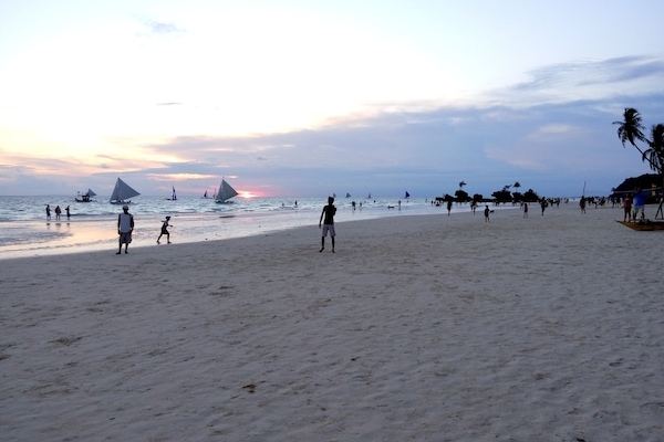 On the beach, white sand, sun loungers, beach umbrellas