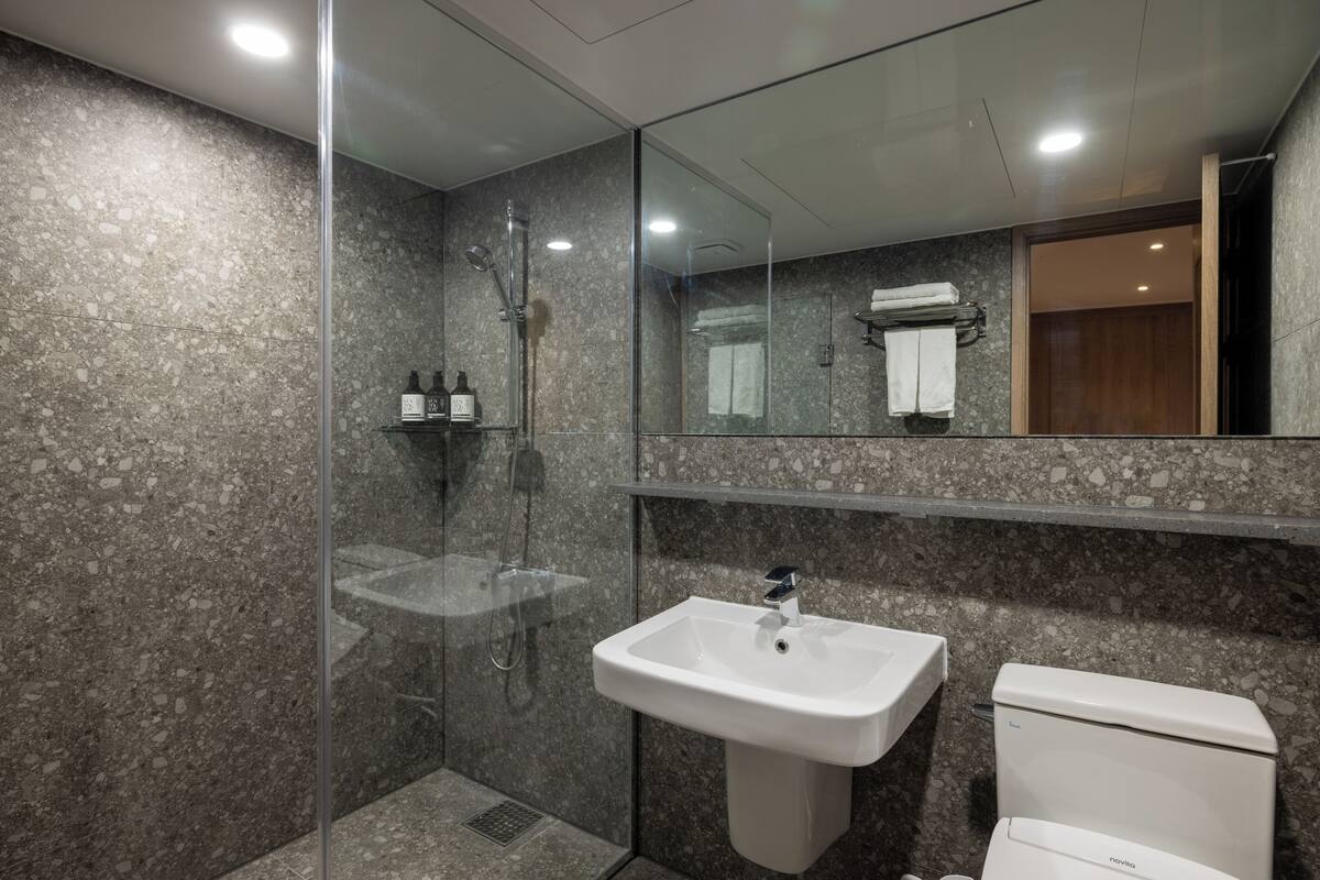 kenshington deluxe (bed type randomly assigned) | bathroom | shower, free toiletries, hair dryer, slippers