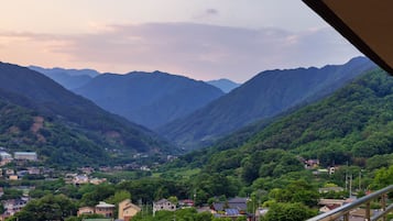 A mountainous landscape with a valley and a small town.