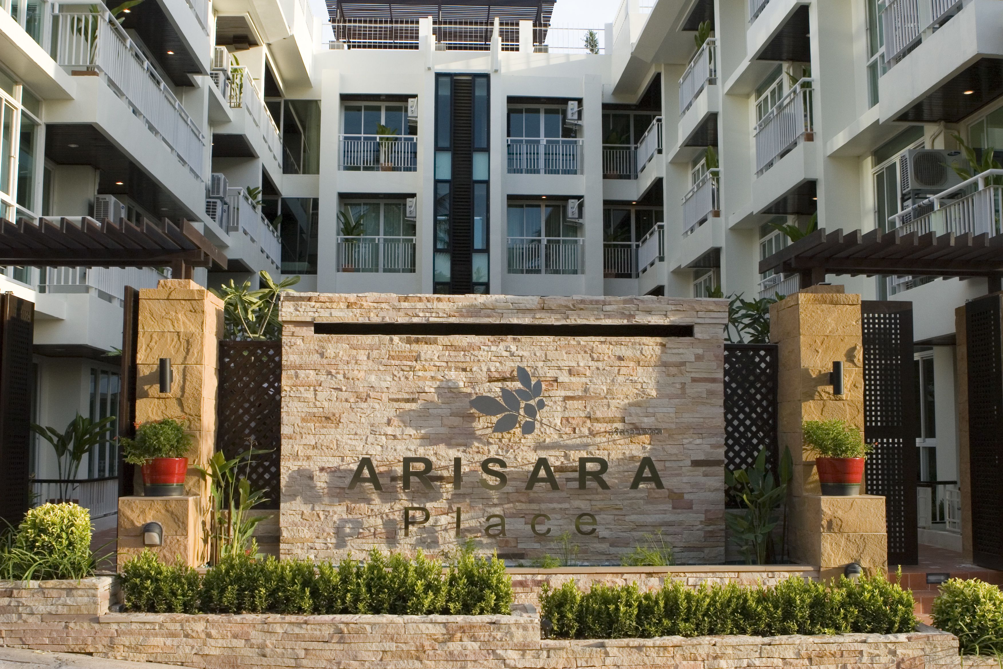 A modern building with a sign reading "ARISARA Place".