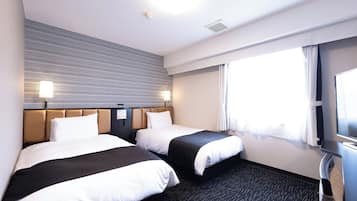 A hotel room with two beds, a large window with curtains, a flat-screen TV, and a wall-mounted control panel.