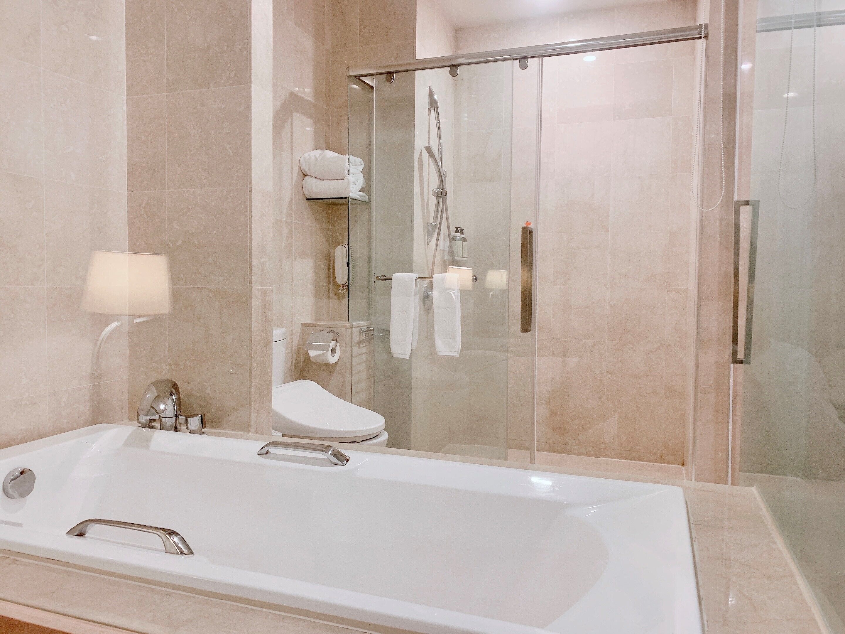 separate bathtub and shower, hair dryer, slippers, towels