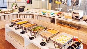 A buffet setup with various food items and serving utensils. - Baron Residence Bangkok (Bangkok)