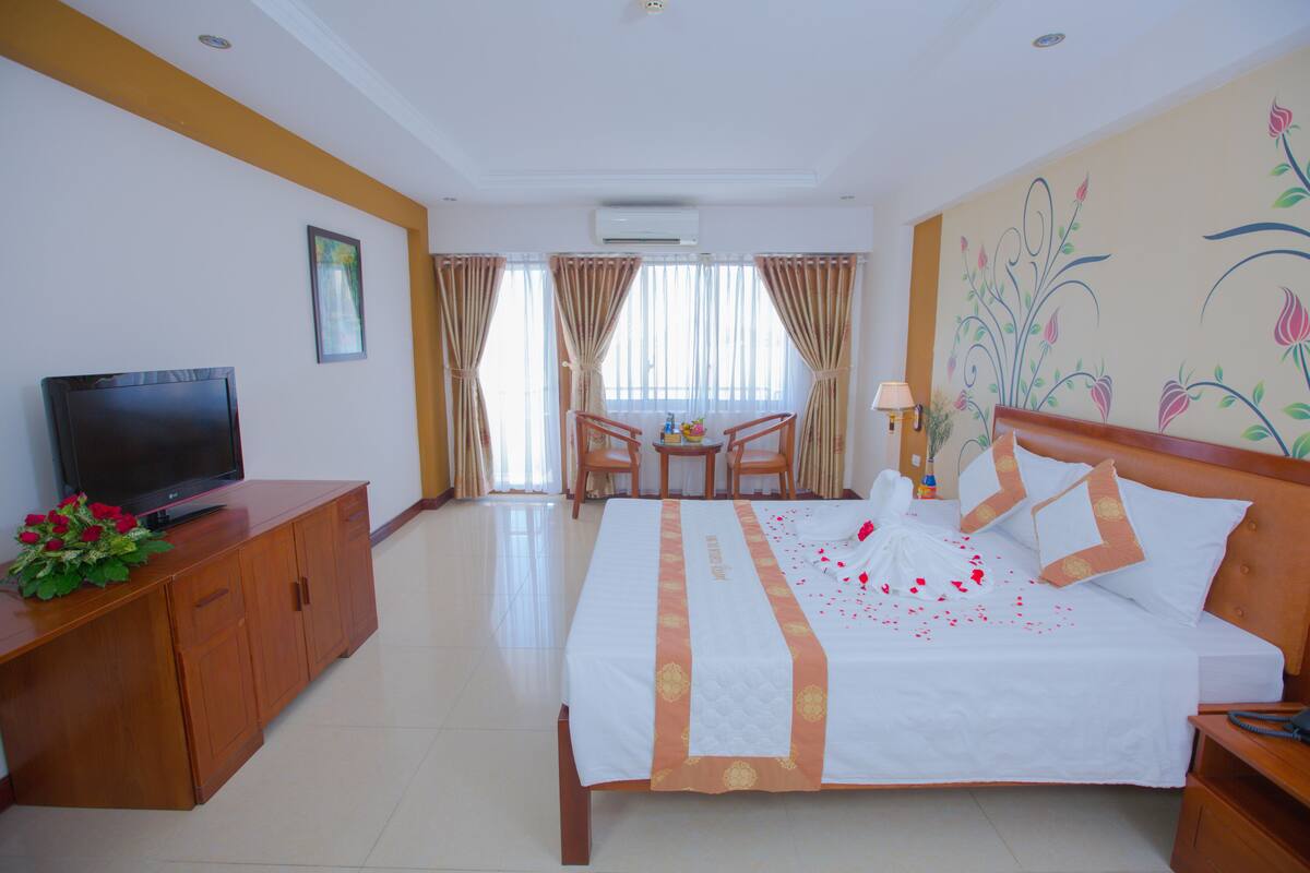 Deluxe Double Room, Partial Sea View | Minibar, in-room safe, desk, blackout drapes