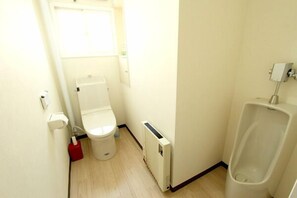 A small, compact bathroom with a toilet, a radiator, and a urinal. - Hakodate Perry House (Hakodate)