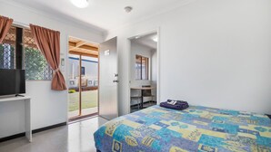 A bedroom with a bed, a desk, a chair, and a television. - Cherratta Lodge (Karratha Industrial Estate)