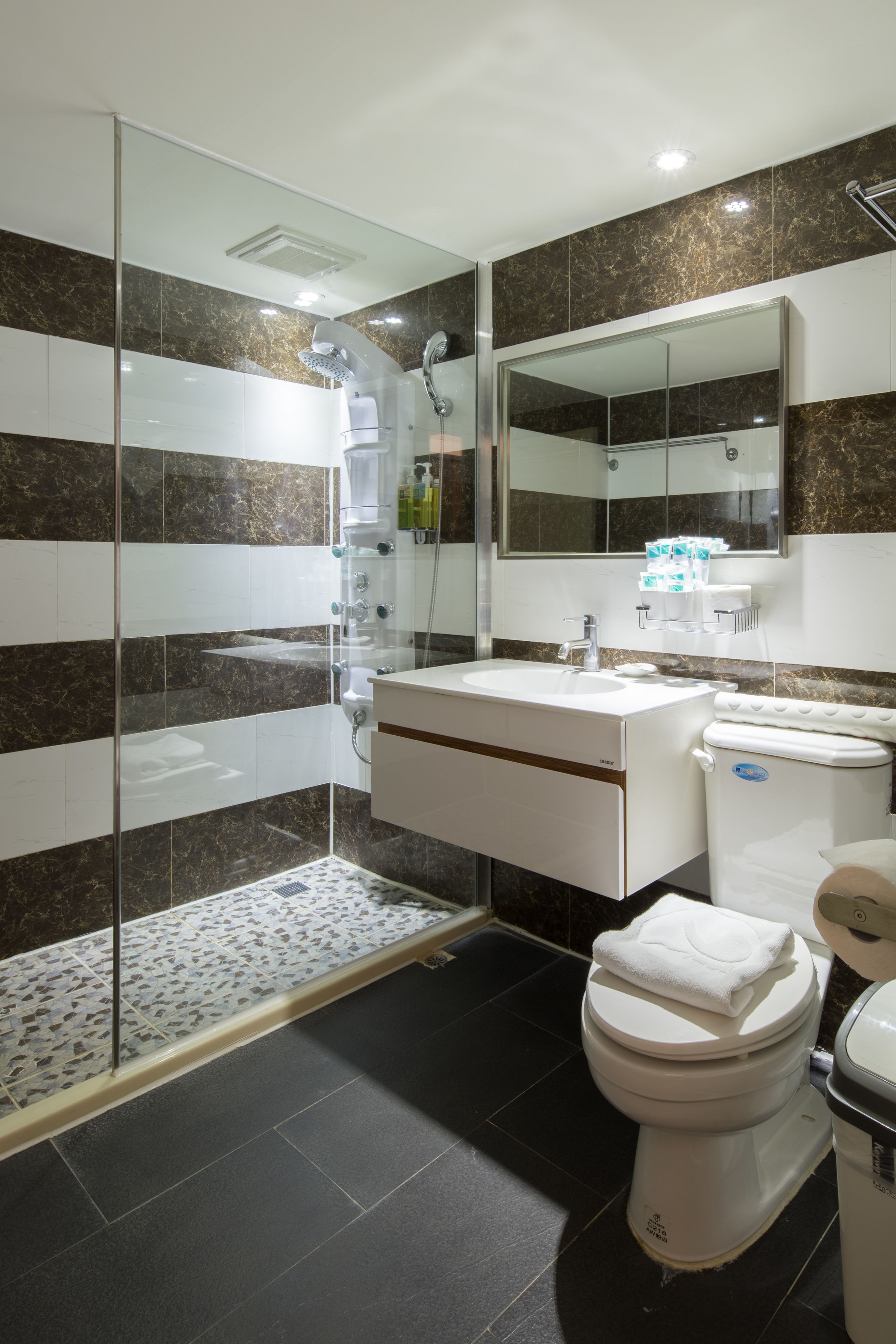 family room | bathroom amenities | shower, rainfall showerhead, hair dryer, slippers