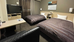 A hotel room with two beds, a desk, a television, and a painting on the wall.