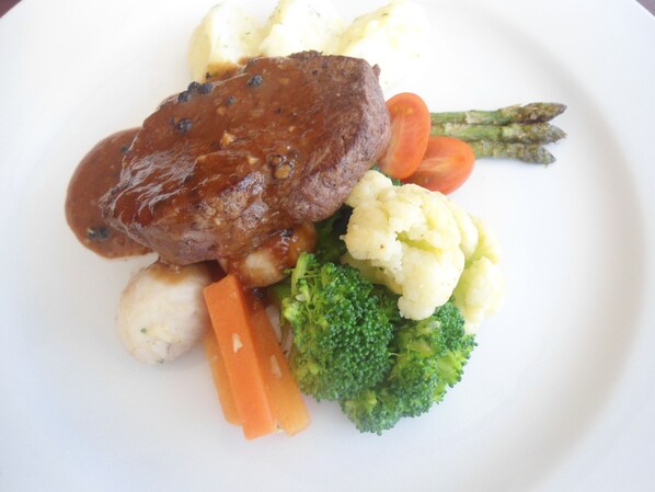 A plate with a steak, mashed potatoes, broccoli, carrots, and asparagus.