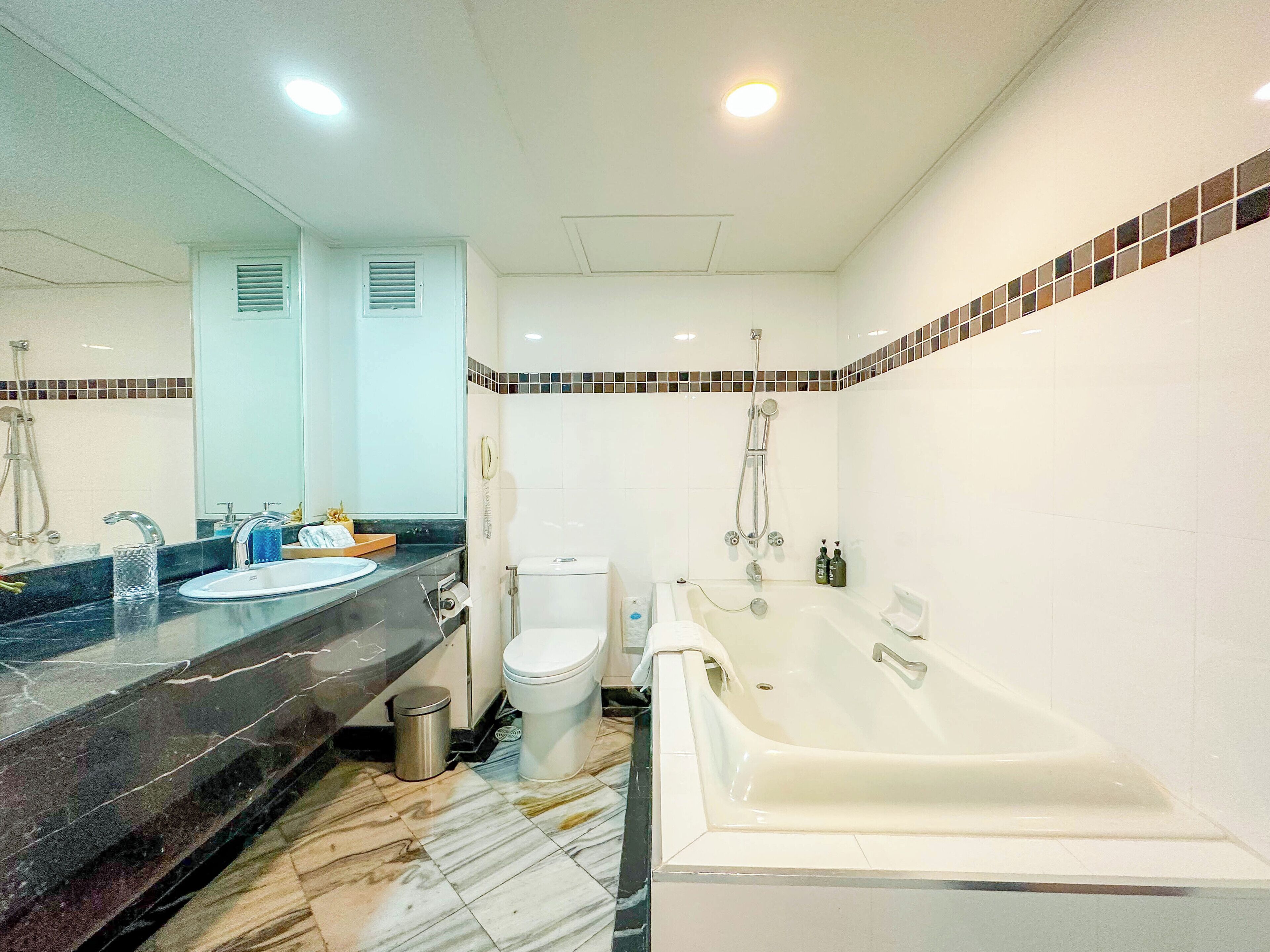A bathroom with a sink, toilet, and bathtub.