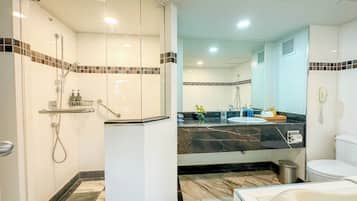 A bathroom with a shower, toilet, sink, and bathtub.